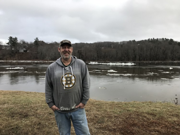 Wayne Hyde, owner of the Hydeout at the Wharf in Hallowell, watches the Kennebec River on Saturday afternoon. Forecasters had expected minor flooding Saturday after rain fell most of Friday across the region, but the river did not reach flood stage. In January, Hyde's business was among those flooded when rain and warm weather caused ice to break up and form a jam in the river at Hallowell.