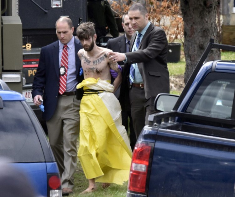 Authorities lead John Williams away in handcuffs April 28.