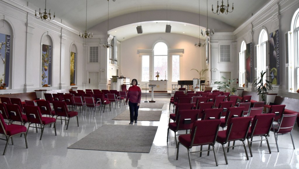 April Cummings, co-owner of Half Pints Day Care, located within the First Congregational Church in Waterville, walks through the church nave Nov. 19. The Waterville City Council will consider a request to rezone the church to accommodate the Children's Discovery Museum, which is working on a lease-purchase agreement with the church.