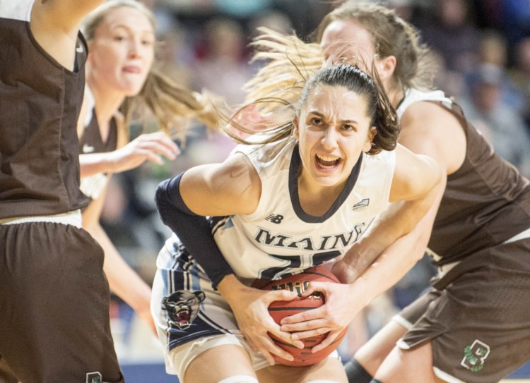 Maine's Blanca Millan gets tied up by Erika Steeves of Brown during Saturday's game at Cross Insurance Center in Bangor. Millan scored a career-high 36 points in Maine's 102-96 overtime win.