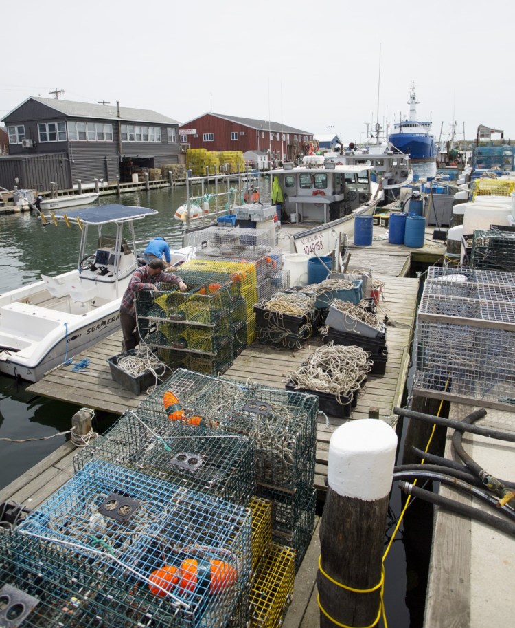 Lobster traps and fishing gear take up most of the dock space at Fish Pier in Portland.