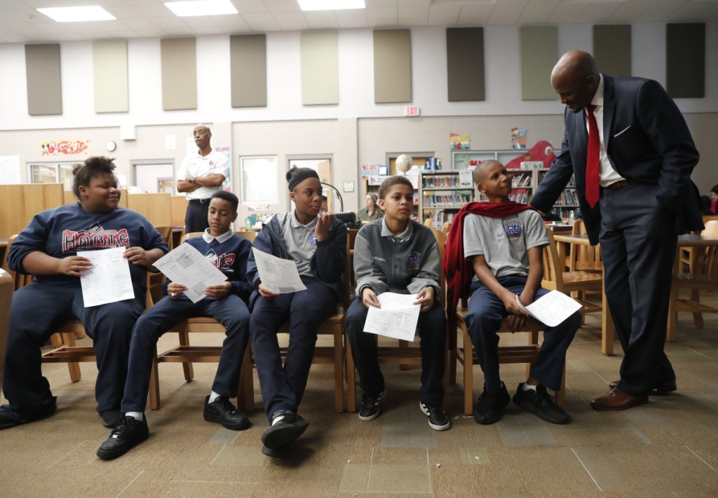 Jamar McKneely, CEO of InspireNOLA Charter Schools, talks with students at Alice M. Harte Charter School in New Orleans.