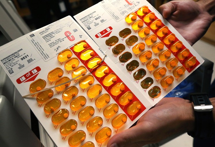 A nurse holds tabs of buprenorphine, a drug that controls heroin and opioid cravings, as he prepares to administer the drug, known by the brand name Suboxone, to selected inmates in Massachusetts in July. Maine has approved major increases in reimbursement rates for health professionals to provide medication-assisted treatment to the thousands of Mainers with opioid use disorder.

