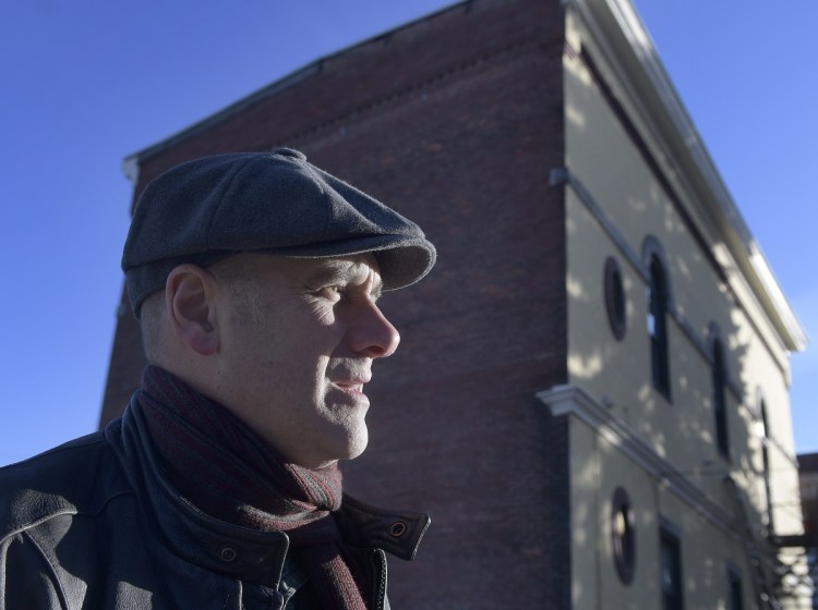 Hallowell artist Chris Cart stands Sunday outside the Vallee Real Estate building on Water Street, where he plans to install a mural of the city's history.