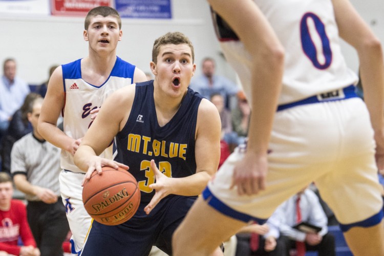 Mt. Blue's Hunter Donald (33) drives to the basket as Messalonskee's Mason Violette defends during a game Friday night in Oakland.