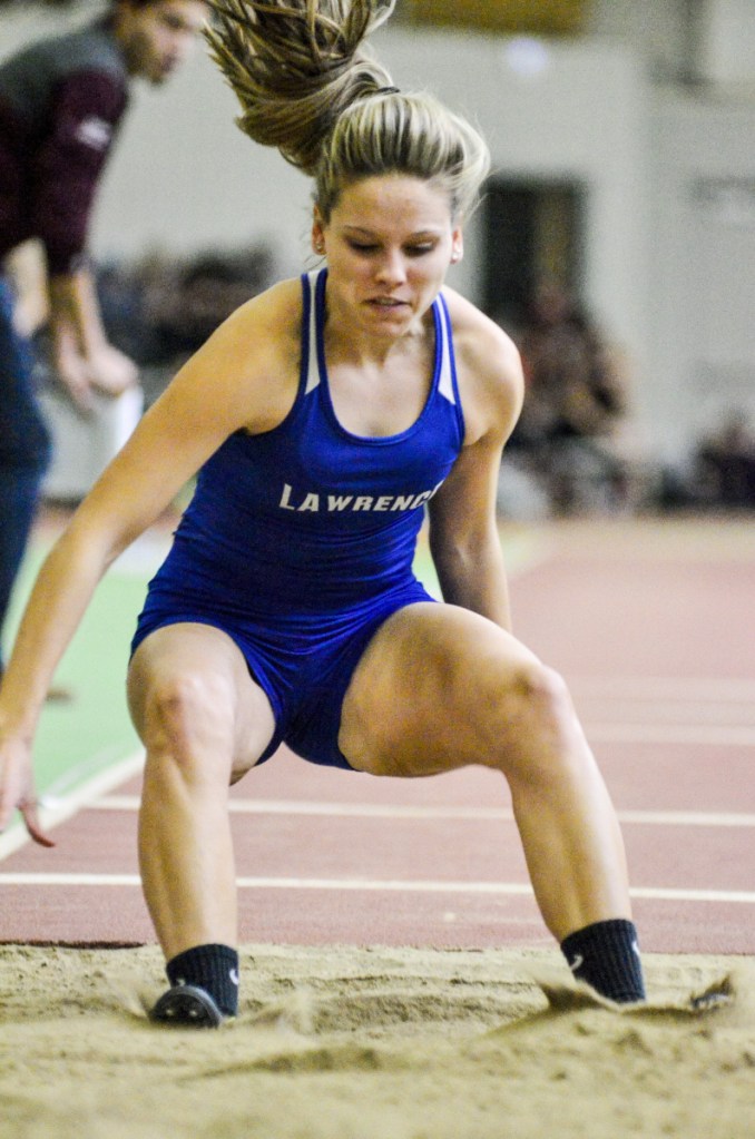 Kennebec Journal photo by Joe Phelan 
 Lawrence's Payton Goodwin lands during the triple jump Saturday at Bowdoin College in Brunswick.