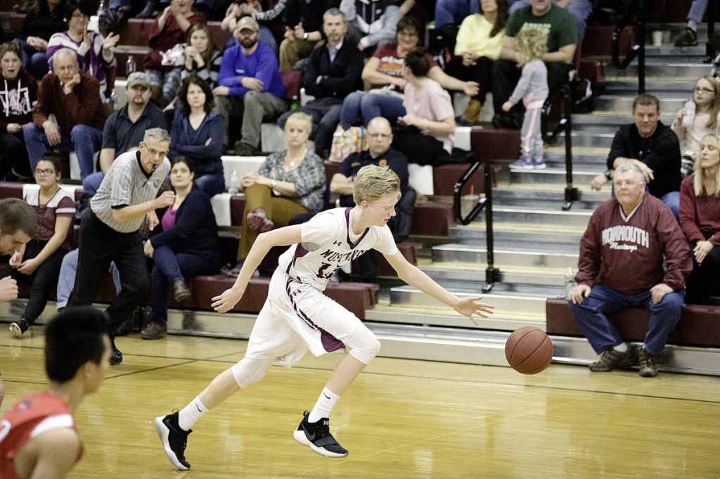 Monmouth's Connor Davies brings the ball up the court against Wiscasett during a game last season in Monmouth.