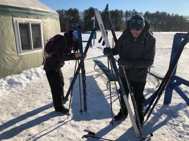 John Elliot, right, and April Lawrence, both of Belfast, gear up for some skiing Saturday at Quarry Road Trails in Waterville.