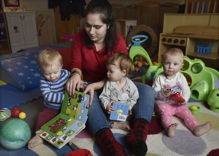 Children's Place assistant teacher Cassidy Brown begins reading to children in the mobile infant room Thursday at the Maine Children's Home for Little Wanderers in Waterville.