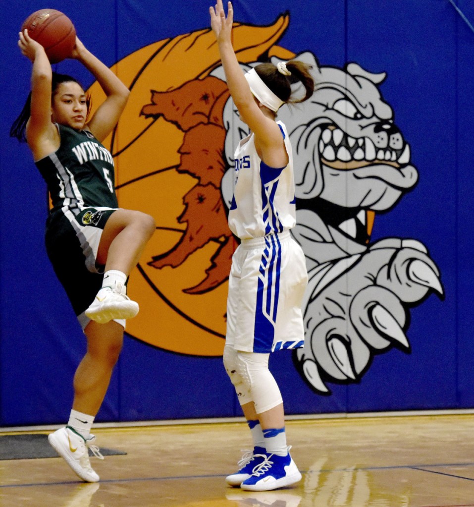 Winthrop's Aaliyah WilsonFalcone, left, looks to pass against a Madison player Monday in Madison.