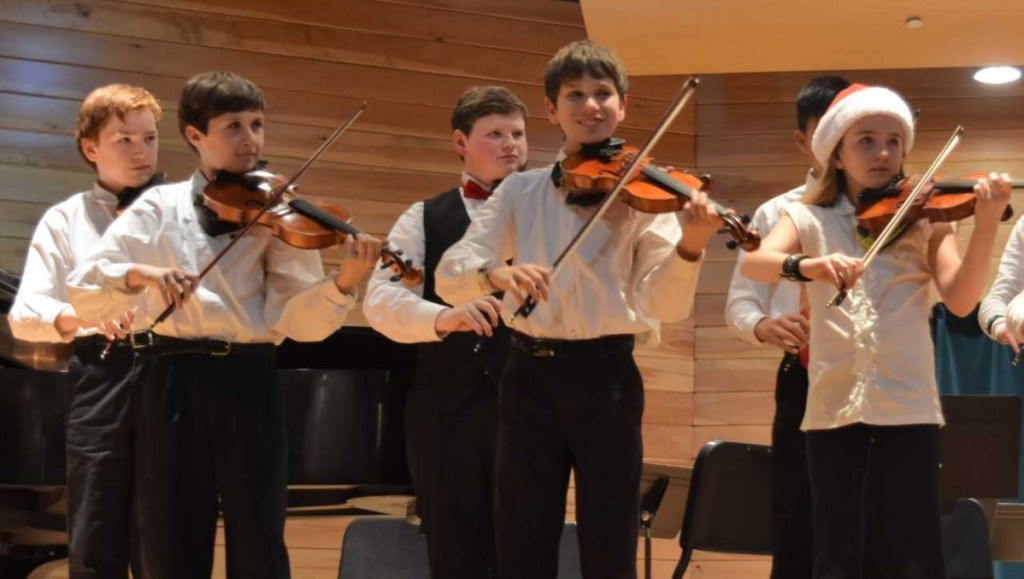 Pineland Suzuki School students, front from left, are Eben Buck, Silas Bartol and Carolyn Phelps Scholz. Back from left are Elijah Huttman and Alex Pierce.