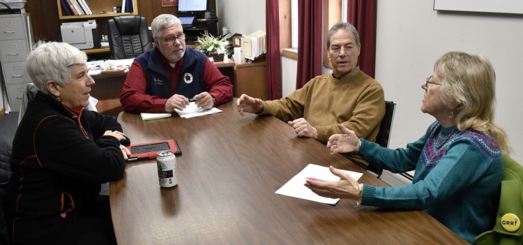 Members of Sustain Mid-Maine Coalition and town managers discuss the recent effort by Waterville Mayor Nick Isgro to oust the coalition from an office in Waterville City Hall. From left are Sally Harwood, vice chairwoman of Sustain Mid-Maine's board of directors; Winslow Town Manager Michael Heavener, who is chairman of Sustain Mid-Maine's board; Waterville City Manager Mike Roy; and Linda Woods, the coordinator of the coalition.