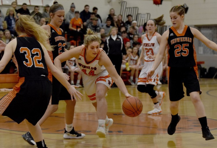 Winslow senior Weslee Littlefield dribbles past Skowhegan defenders during a Kennebec Valley Athletic Conference game Tuesday night in Winslow.