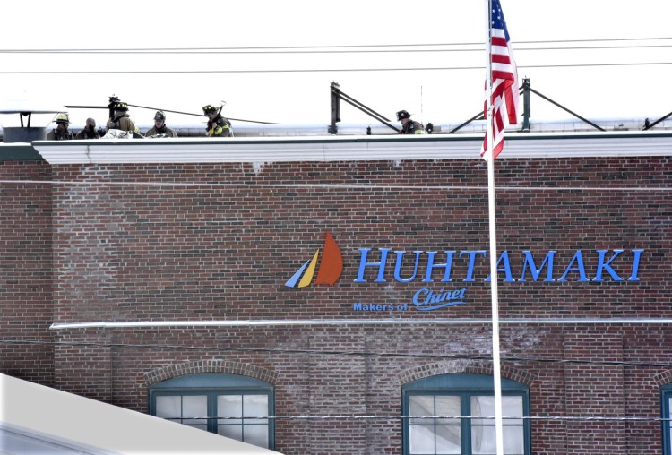 Firefighters from Waterville, Fairfield and Winslow found themselves back on the roof of the Huhtamaki mill after fire rekindled Wednesday from a fire that had started Tuesday evening. A company spokesman said sections of the plant unaffected by the fire were up and running Thursday, and those affected by the fire would be operational within four weeks.