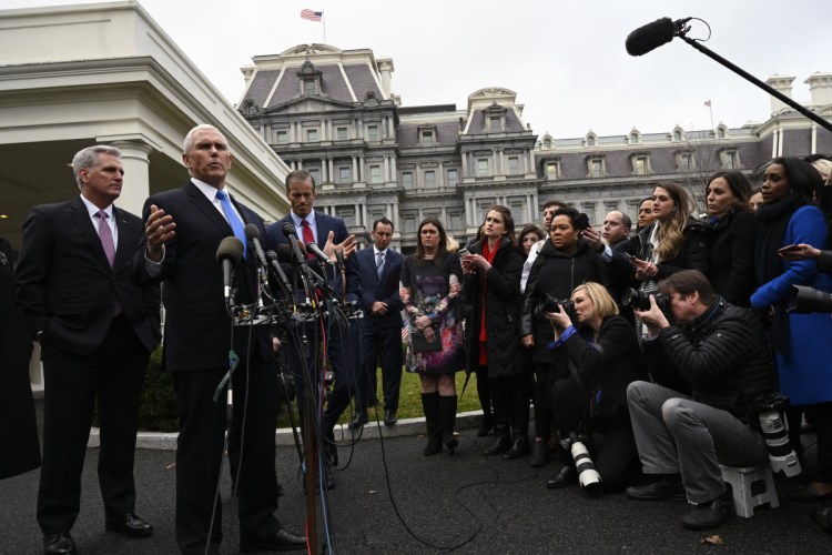 Vice President Mike Pence, second from left, standing with House Minority Leader Kevin McCarthy of Calif., left, and Sen. John Thune, R-S.D., third from left, answers a question after a meeting with President Trump and Democratic leaders at the White House on Wednesday.