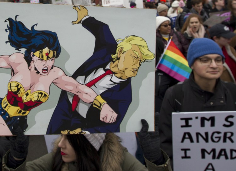 Demonstrators hold up their banners on Pennsylvania Avenue during the Women's March in Washington on Saturday.
