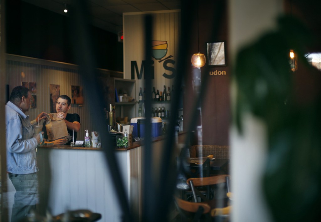 Dan Aceto helps a customer at Mi Sen Noddle Bar on Monday. The restaurant on Congress Street was robbed on Saturday night.