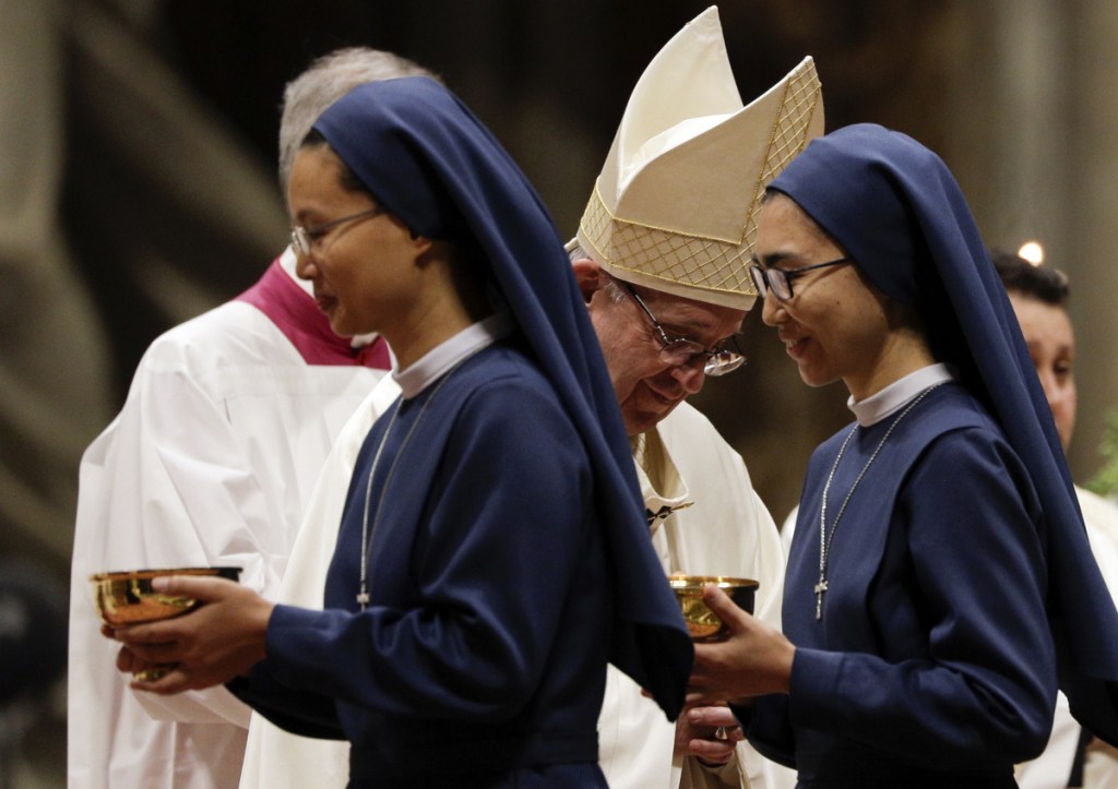 Nuns pass Pope Francis during a Mass at the Vatican. The U.S.-based Leadership Conference of Women Religious says the church needs to change a male-led leadership that allows abuse of women to remain hidden.