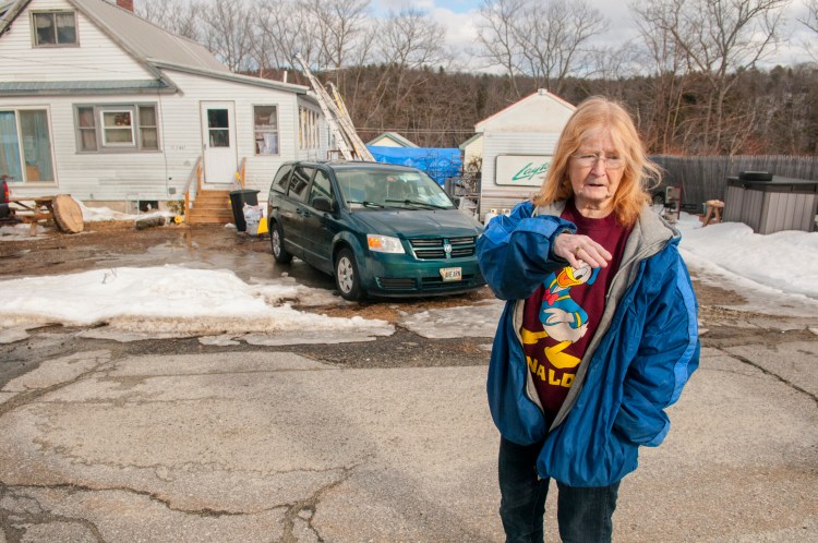 Merleen Ahearn talks about drainage problems Jan. 25 in front of her home on Clark Street Extension in Farmingdale.