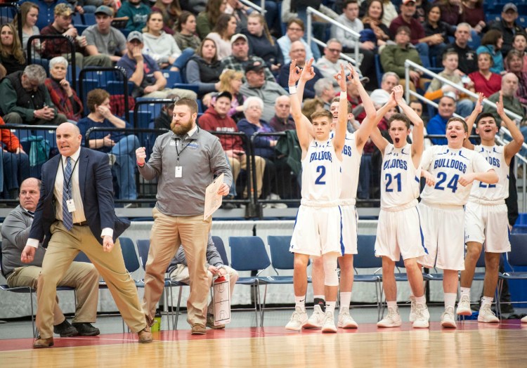 The Lawrence High School bench celebrates a 3-pointer during the Class A North championship game against Skowhegan last Friday night at the Augusta Civic Center.