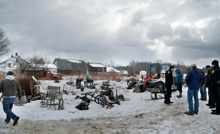 Workers from JARR Management and Richmond town officials confer Monday during the cleanup of the Smith property in Richmond.