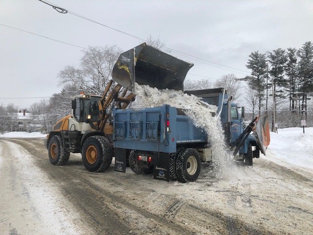William Marsh uses a front-end loader Thursday to clean ice and snow from Main Street Skowhegan into a waiting Highway Department truck driven by Walter Powell. The loads go to one of three snow dumps in town. Morning Sentinel photo by Doug Harlow.
