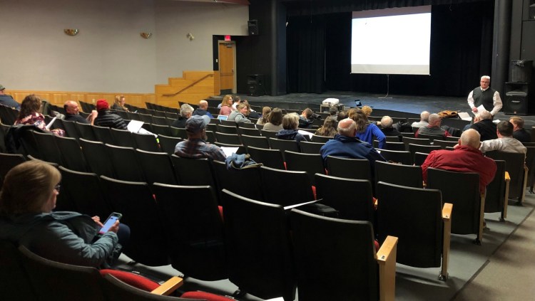 Winslow Superintendent Peter Thiboutot addresses a crowd of residents and local officials Tuesday night at the Winslow High School auditorium.