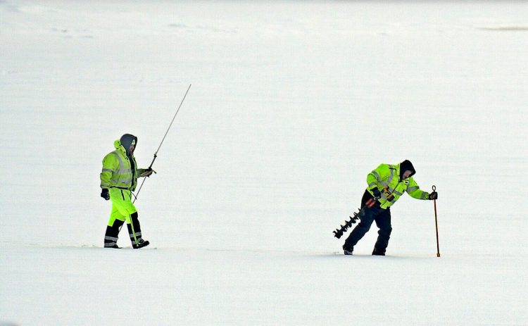 US Geological Service hydrological technicians Jason Cyr, right, and Jeremiah Pomerleau pound ice Wednesday on the Kennebec River in Gardiner while collecting samples. The federal agency was collecting data on the thickness of ice from rivers across Maine ahead of a flood watch meeting with the Maine Emergency Management Agency on Thursday. 