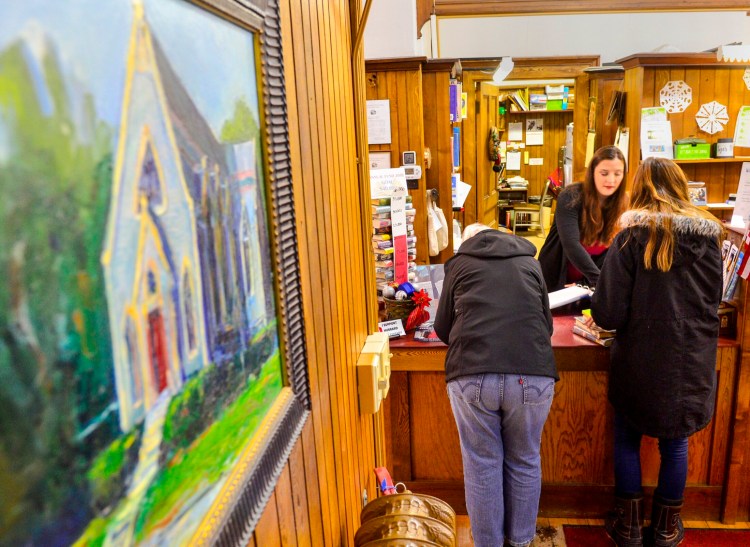 Annemarie Kromhout, director of the Hubbard Free Library, works behind the circulation desk Jan. 16, 2019 at the library in Hallowell.