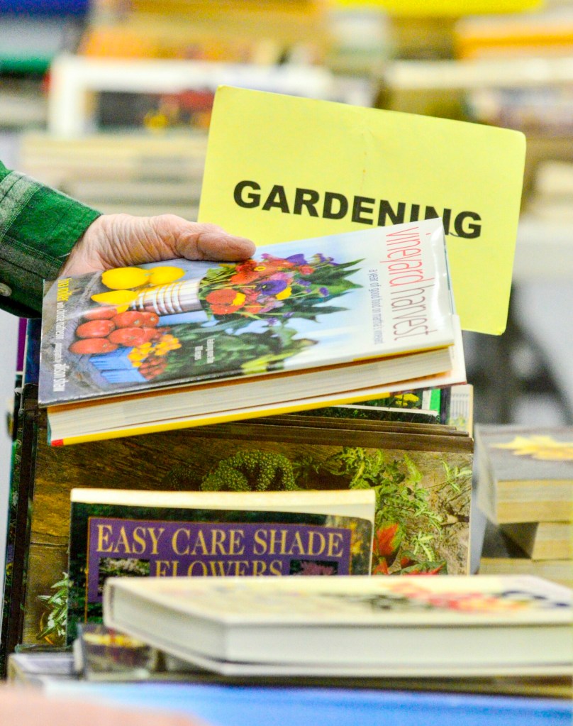 Shoppers browse among the tables Saturday during the Friends of the Belgrade Library book sale in the Belgrade Central School gymnasium.