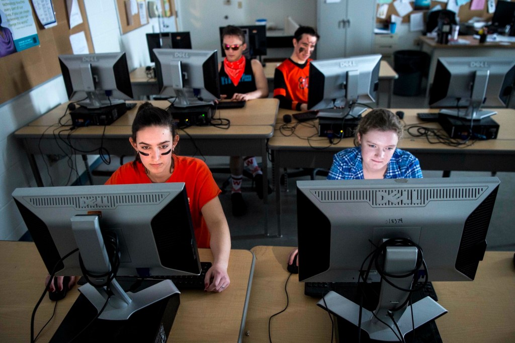 Winslow High School students Arianna Hatt, front left, Carrie Selwood, front right, Devin Daigneault, back left, and Nick Tiner work on their computers during computer programming class at Winslow High School on Friday. Next school year, the high school will introduce an AP Computer Science course called the Beauty and Joy of Computing for students.