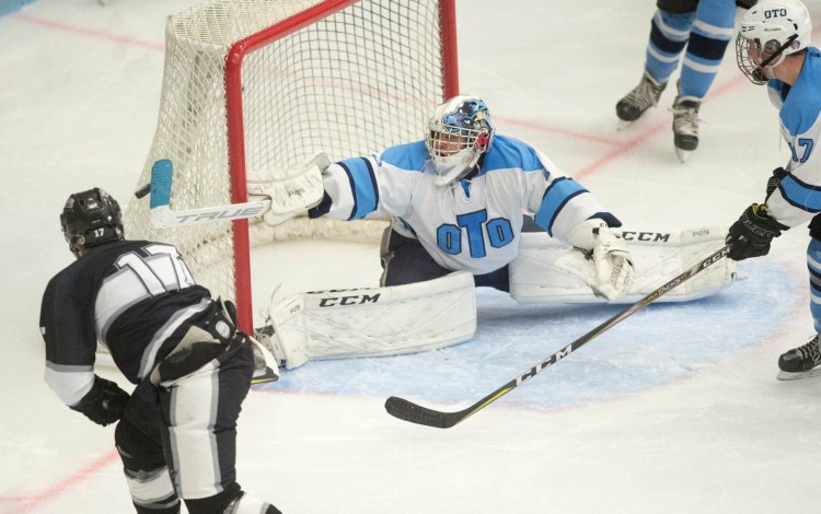 Old Town/Orono goalie Kohle Parker makes a stick save on a shot from Kennebec's Cooper Hart (17) in the third period in the Class B North final Wednesday at the Alfond Arena at the University of Maine in Orono.