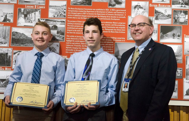 Windsor Elementary students and essay contest winners Caleb Gay, left, and Jeremy Parker pose for a photo with Maine Secretary of State Matt Dunlap on Thursday at the Maine Archives in Augusta.