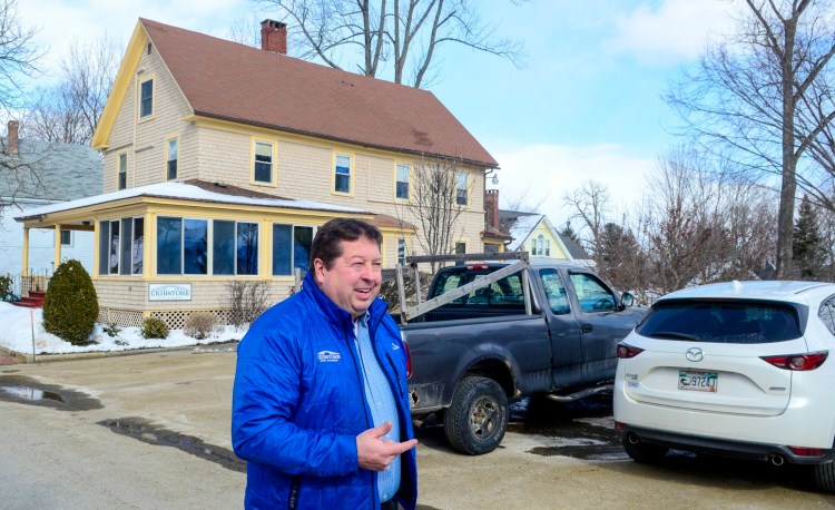 Scott Upham, managing partner of Cribstone Capital Management, talks about the parking controversy near his office, in background, on Thursday on North Chestnut Street in Augusta.