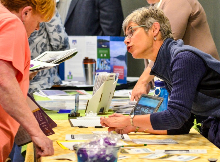 Janet Sawyer, of the Kennebec Land Trust, talks to people about volunteering at the group's Howard Hill project on Saturday at Lithgow Public Library in Augusta.