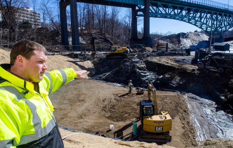 Andrew Begin, assistant general manager of the Greater Augusta Utilities District, talks about construction of a 1-million-gallon storage tank Tuesday on the east side of Kennebec River in Augusta.