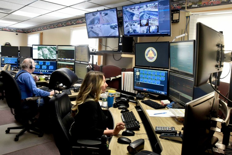 Somerset County Regional Communication Center dispatchers Stephen Crowe and Kelly Putnam monitor radio traffic in Skowhegan on Thursday. The RCC services 19 Kennebec County towns. The organization was faced with a choice of adding staff or cutting services, and decided to cut services to Augusta and Hallowell.