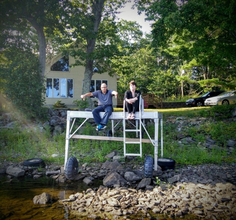 Robert Rubin and Cheryl Ayer sit on the dock at their Clary Lake property in Whitefield in August 2015, when the level in Clary Lake was more than 5 feet below the top of the Clary Lake dam.  