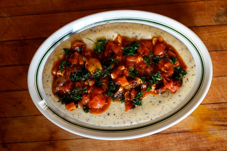 BRUNSWICK, ME - OCTOBER 14: Roasted Tomatoes, Shallots and Honey Nut Squash with Polenta and Fried parsley Thursday, October 14, 2021. (Shawn Patrick Ouellette/Staff Photographer)