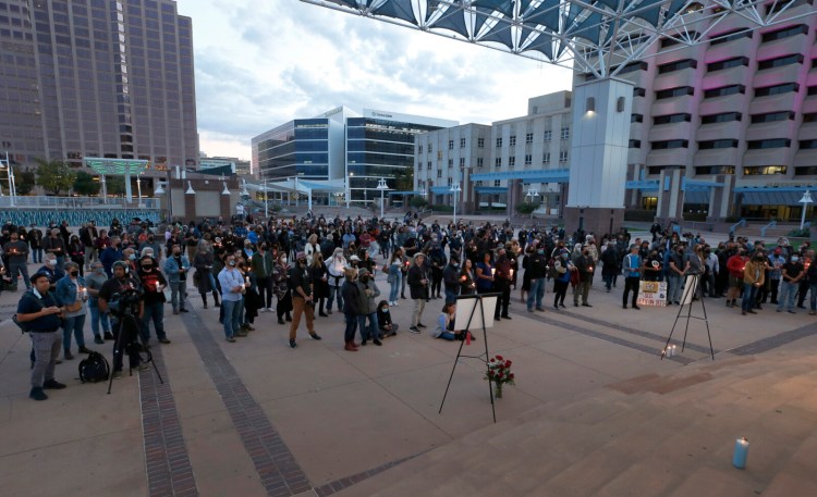 FILE - A large crowd of movie industry workers and New Mexico residents attend a candlelight vigil to honor cinematographer Halyna Hutchins in downtown Albuquerque, N.M. Saturday, Oct. 23, 2021. Hutchins was killed when Alec Baldwin fired a weapon on a film set that a crew member told him was safe. The tragedy has led to calls for fundamental change in Hollywood: the banning of real guns on sets. (AP Photo/Andres Leighton, file)