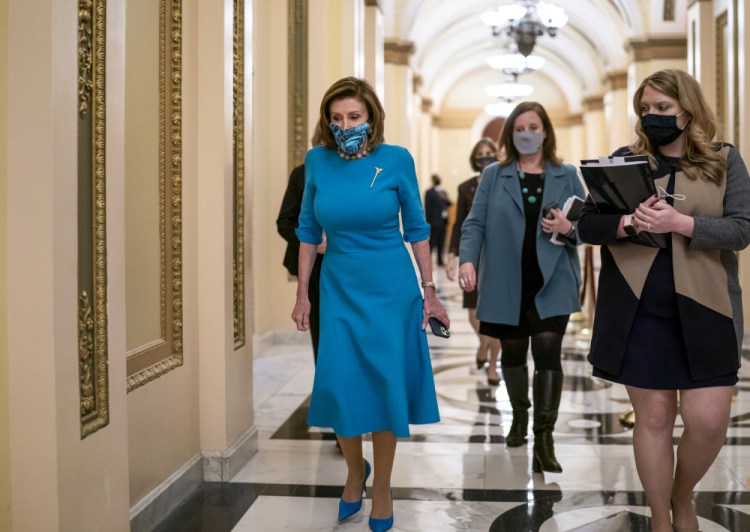 Speaker of the House Nancy Pelosi, D-Calif., leaves the chamber after midnight during a lengthy floor speech by House Minority Leader Kevin McCarthy, R-Calif., who disrupted a planned vote on President Joe Biden's domestic agenda, the Build Back Better Act, at the Capitol in Washington, early Friday, Nov. 19, 2021. 