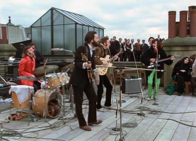 Ringo Starr, Paul McCartney, John Lennon and George Harrison, with Yoko Ono, seated right, in a scene from the nearly 8-hour Peter Jackson-produced documentary “Get Back,” airing over three days starting Thanksgiving. 