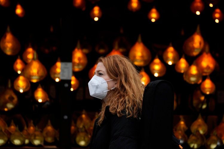 A woman passes Christmas lights in London on Wednesday.
