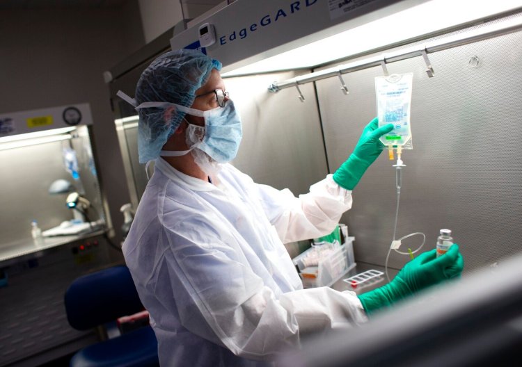 Dan Pelletier, a pharmacy technician specialist at Maine Medical Center, demonstrates the process of preparing anitibodies used to treat COVID19 patients. 