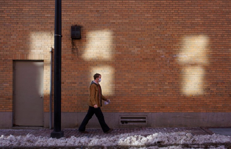 A man walks along Brown Street in Portland on Monday. Mainers are facing constant choices about how to navigate this rapidly changing phase of the pandemic.