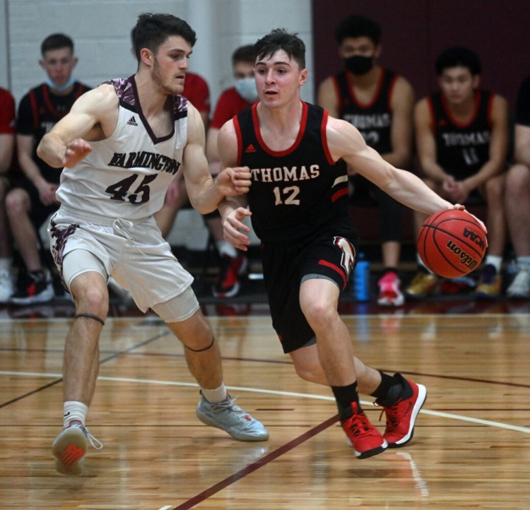 17199# 01menshoops FARMINGTON, MAINE Thomas CollegeÕs Parker Desjardins, right, drives the ball around UMaine-Farmington defender Silas Mohlar during basketball action at UMaine-Farmington in Farmington, Maine Tuesday January 25, 2022.(Rich Abrahamson/Morning Sentinel)