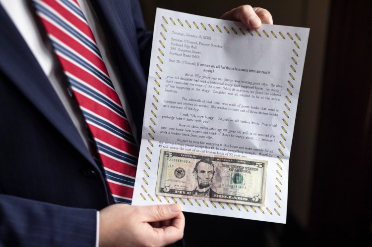 Brendan O'Connell, Portland’s finance director, with the letter he received from a man who sent $5 to pay for a broken sidewalk brick his daughter took home as a souvenir from the city about 50 years ago.