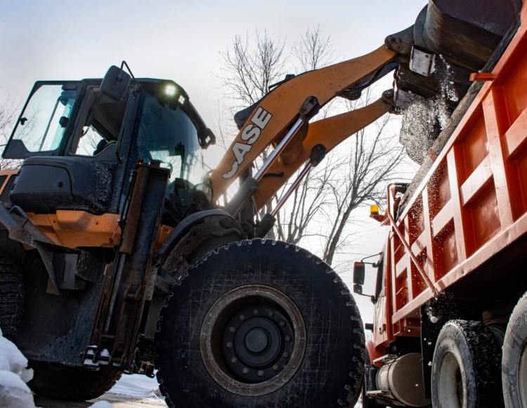 Augusta Public Works employees remove snow Thursday from Fairfield Street to make room for more snow that's forecast to arrive Saturday. The snow is trucked to a large pile under the Memorial Bridge.