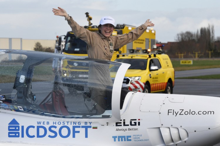 Zara Rutherford celebrates after landing her Shark ultralight plane in Kortrijk, Belgium, on Thursday.