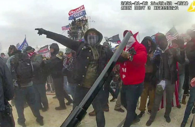 This image of Brian Christopher Mock, center, was captured in police body-worn video on the West Front of the U.S. Capitol in Washington, on Jan. 6, 2021. (Justice Department via AP)